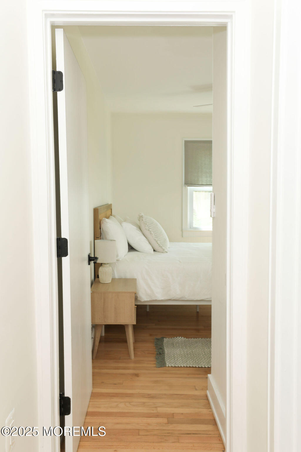 153 Atlantic Avenue Long Branch, NJ 07740 - Photo 34 of 46 a bedroom with a bed and a mirror