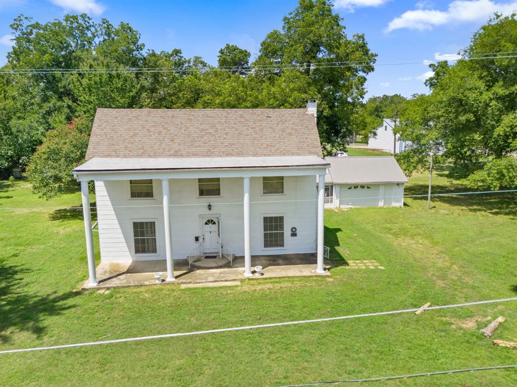 260 South Main Street Detroit, TX 75436 - Photo 16 of 20 a view of a house with pool garden and trees