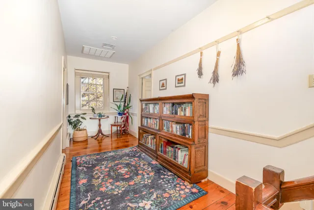 a bedroom with a bed a chair and potted plant