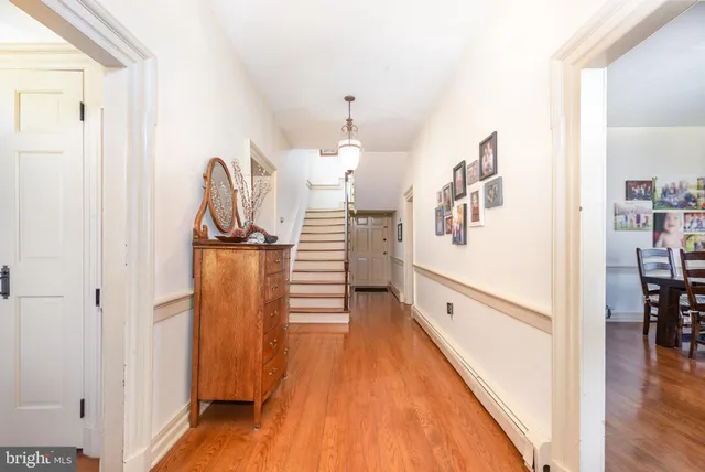 a view of a kitchen with wooden floor and staircase