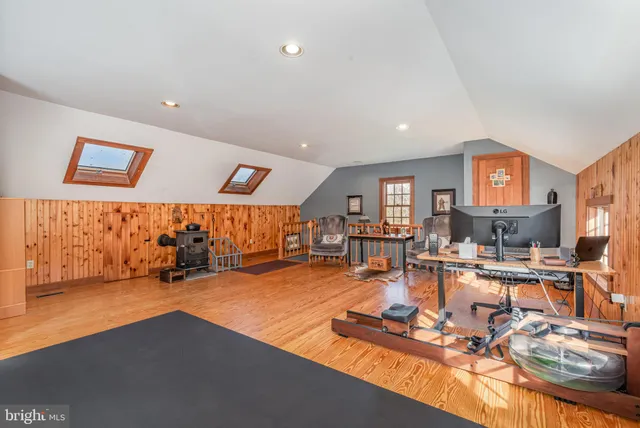 a balcony with chairs and wooden fence