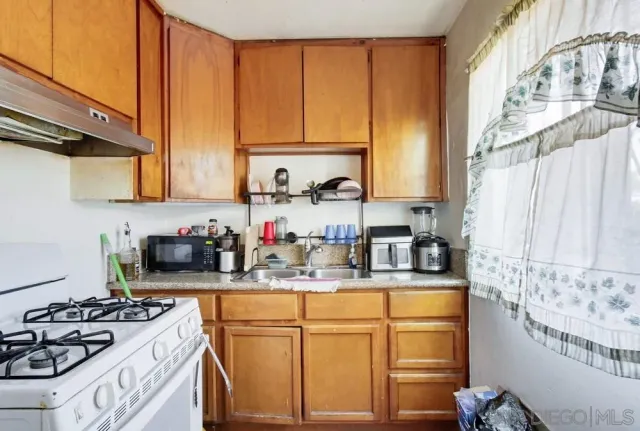 a bedroom with bed and a flat tv screen on dresser
