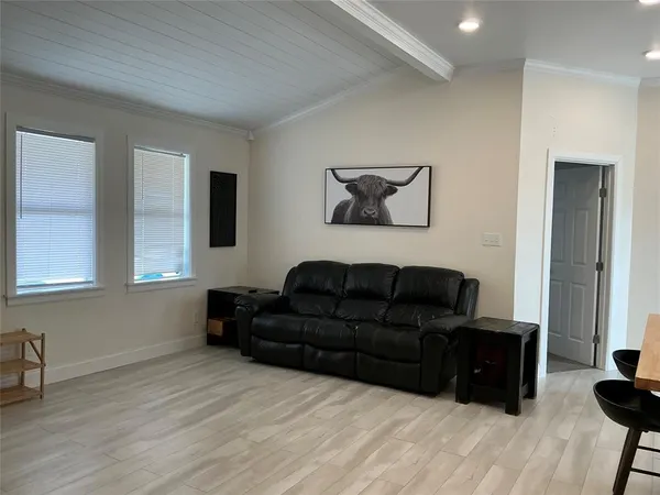 a kitchen with stainless steel appliances kitchen island granite countertop a table chairs sink and cabinets