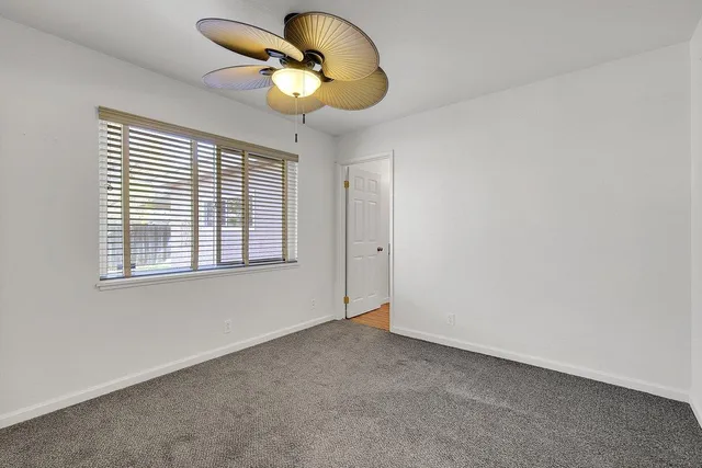 a view of room with a ceiling fan and window