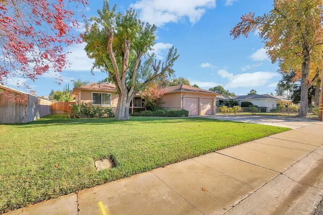 a house view with swimming pool in front of it