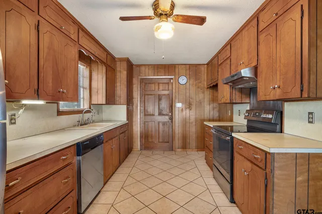 a kitchen with stainless steel appliances granite countertop a sink and cabinets