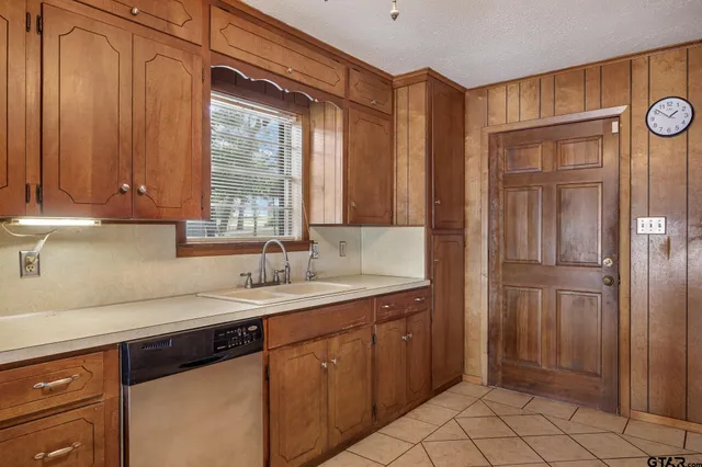 a kitchen with a sink cabinets and window