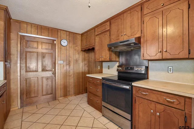 a kitchen with a stove and a refrigerator
