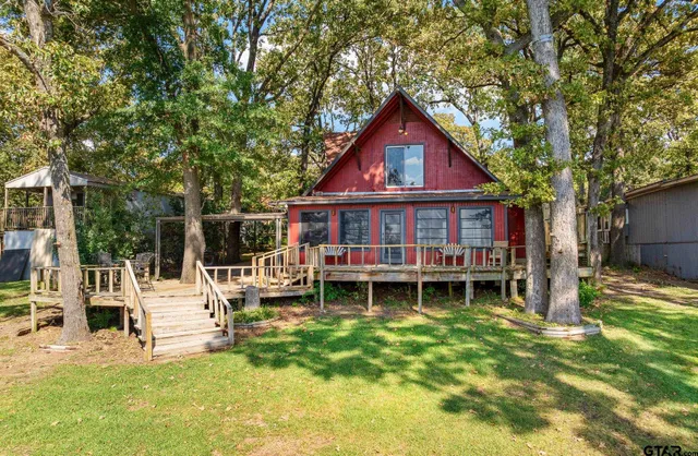 a front view of a house with a yard table and chairs
