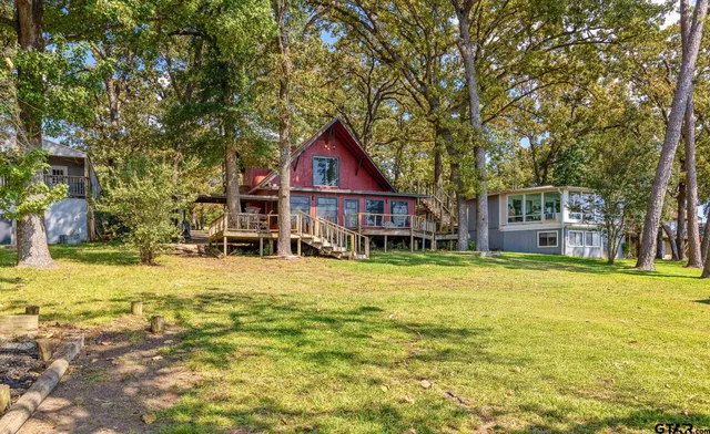 a house view with swimming pool in front of it