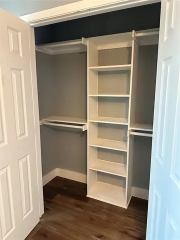 a view of walk in closet with empty racks
