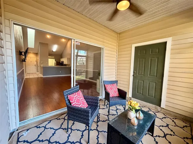 a balcony with furniture and wooden floor