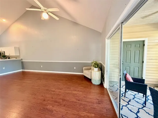 a view of an empty room with furniture and a window