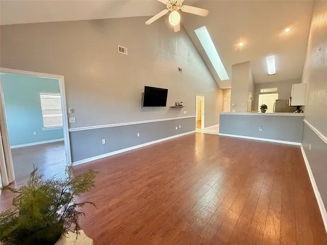 a view of a living room a room with wooden floor and fan