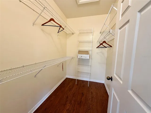 a view of walk in closet with empty racks