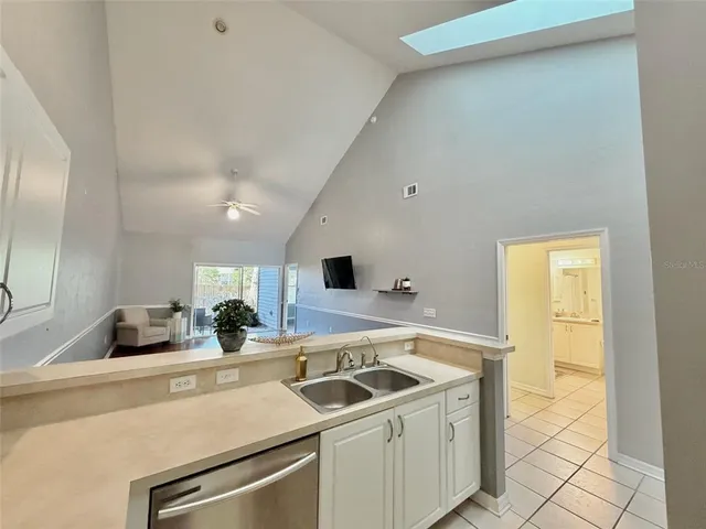 a kitchen with a sink and a stove top oven