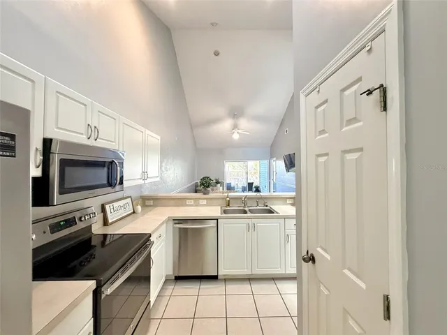 a kitchen with a sink stainless steel appliances and cabinets