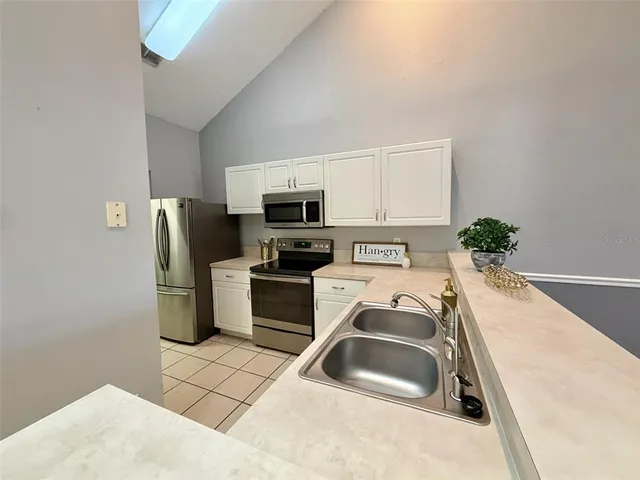 a kitchen that has a sink and a stove top oven