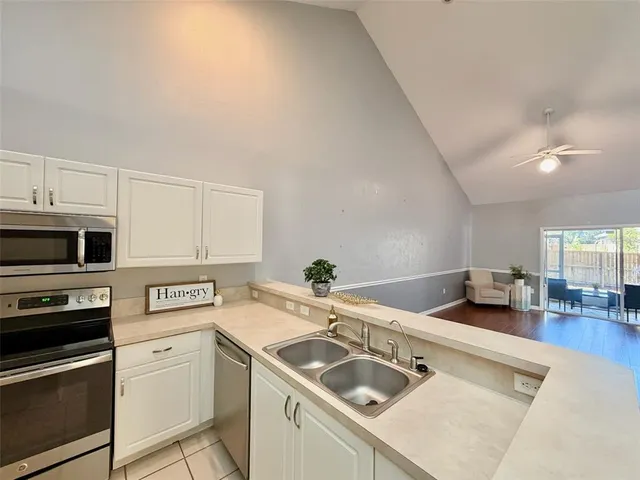 a kitchen that has a sink and a stove top oven