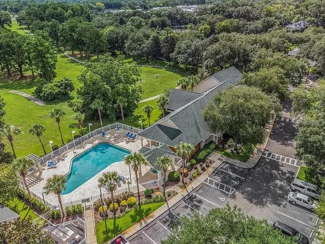 an aerial view of a house with a yard
