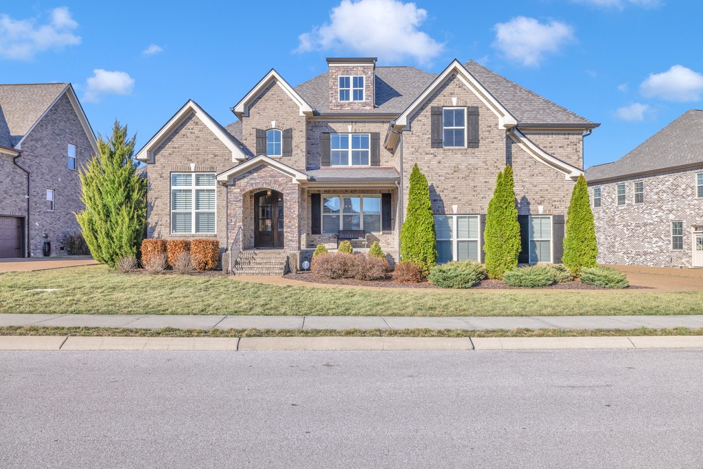 a front view of house with yard and green space