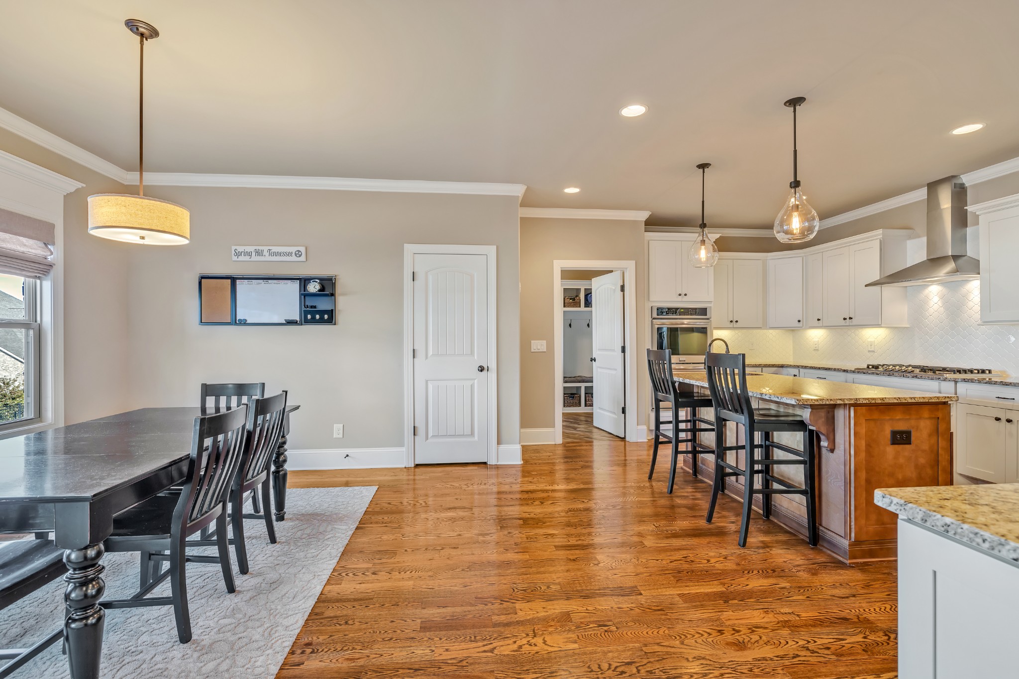 4008 Canberra Drive Spring Hill, TN 37174 - Photo 25 of 63 a view of a dining room and livingroom with furniture wooden floor a chandelier