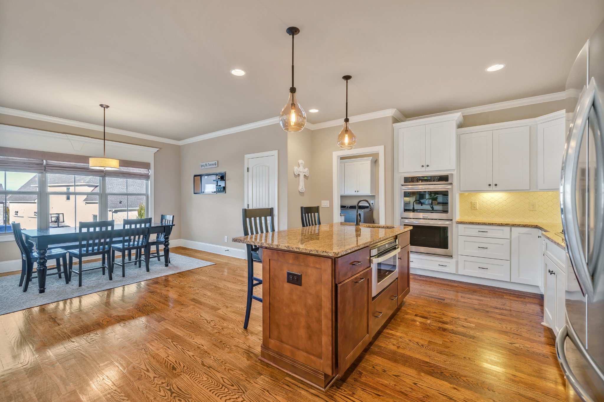4008 Canberra Drive Spring Hill, TN 37174 - Photo 29 of 63 a kitchen with stainless steel appliances kitchen island granite countertop a table chairs and a stove