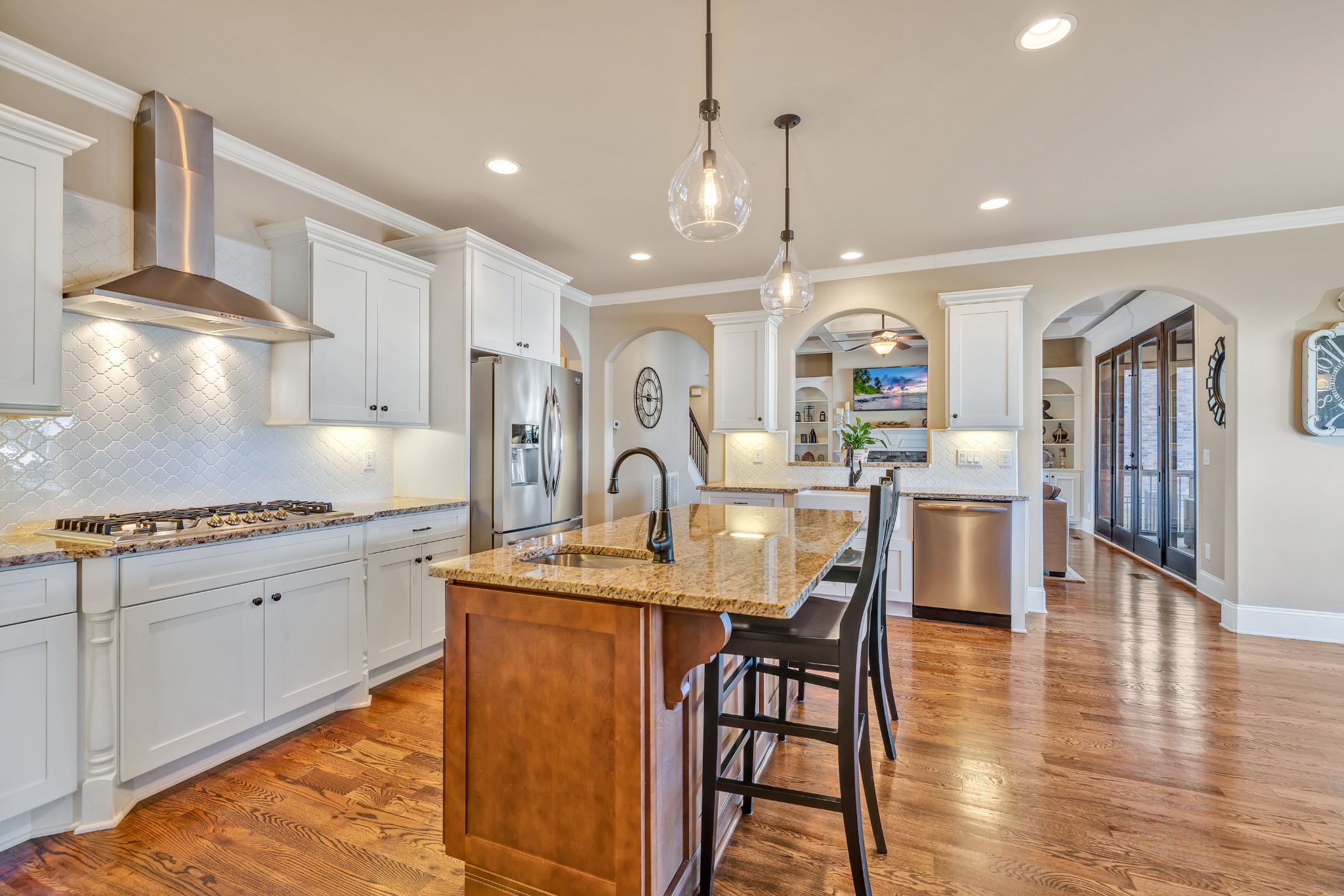 4008 Canberra Drive Spring Hill, TN 37174 - Photo 32 of 63 a kitchen with stainless steel appliances granite countertop a stove top oven a sink a dining table and chairs with wooden floor