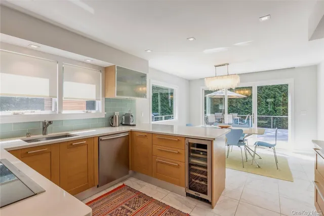 a kitchen with a sink a counter and chairs