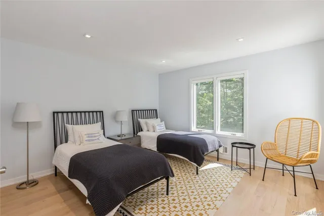 a bedroom with two beds and a window