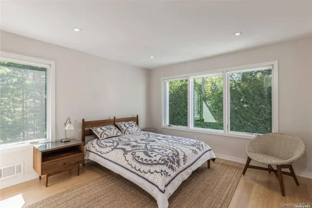 a bedroom with a bed a table and chair