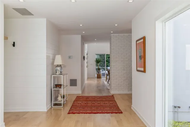 wooden floor in a hall with a dining table and chairs