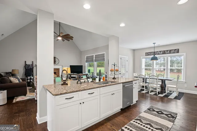 a bedroom with a bed and flat tv screen on the dresser
