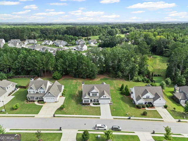 an aerial view of a house with garden space and street view