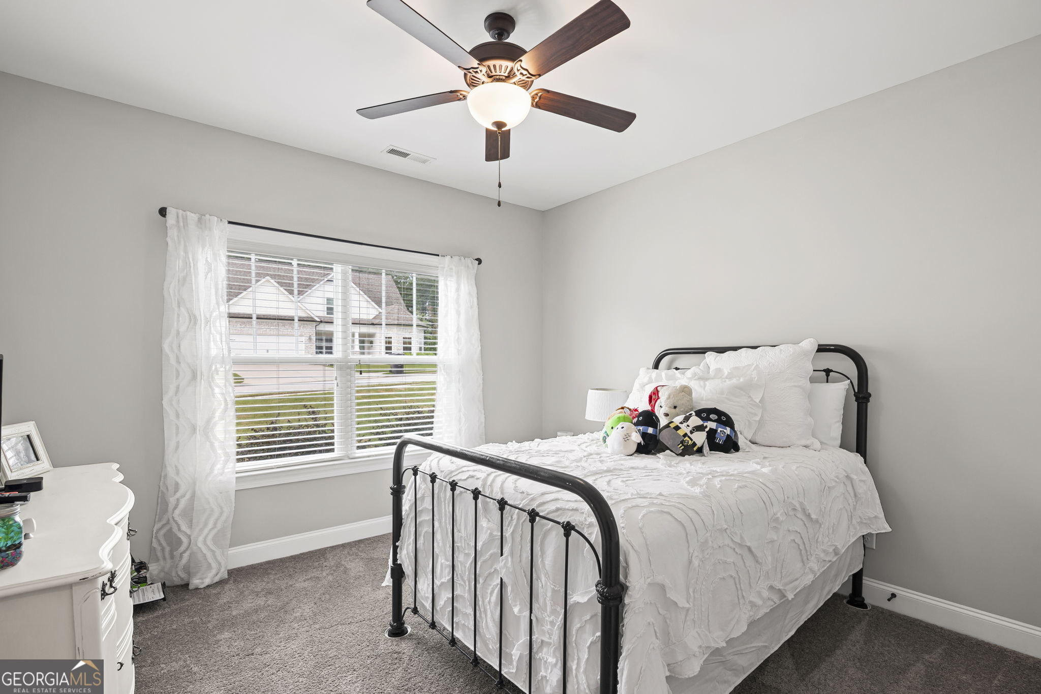 150 Duck Drive Senoia, GA 30276 - Photo 25 of 73 a bedroom with a large bed and a chandelier