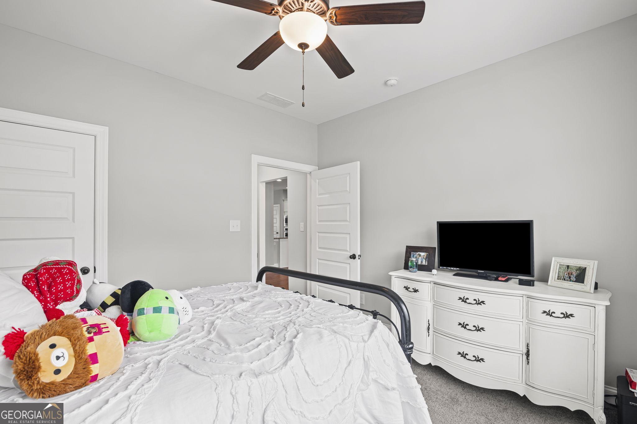 150 Duck Drive Senoia, GA 30276 - Photo 26 of 73 a bedroom with a bed and flat tv screen on the dresser