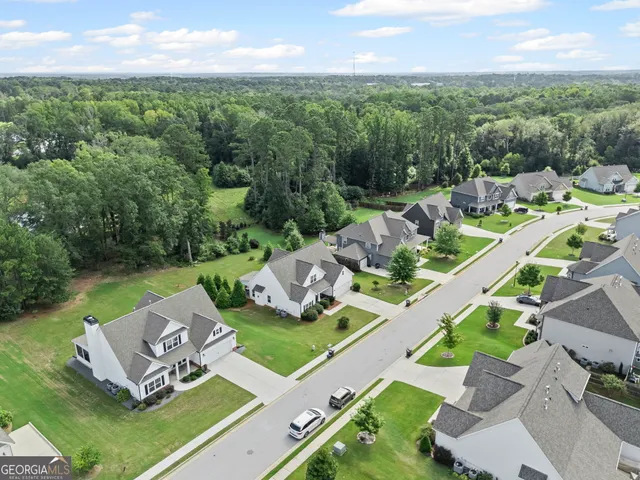 an aerial view of a house with swimming pool garden and patio