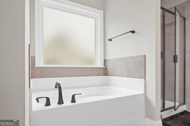 a view of a yard in front of a house with a large tree