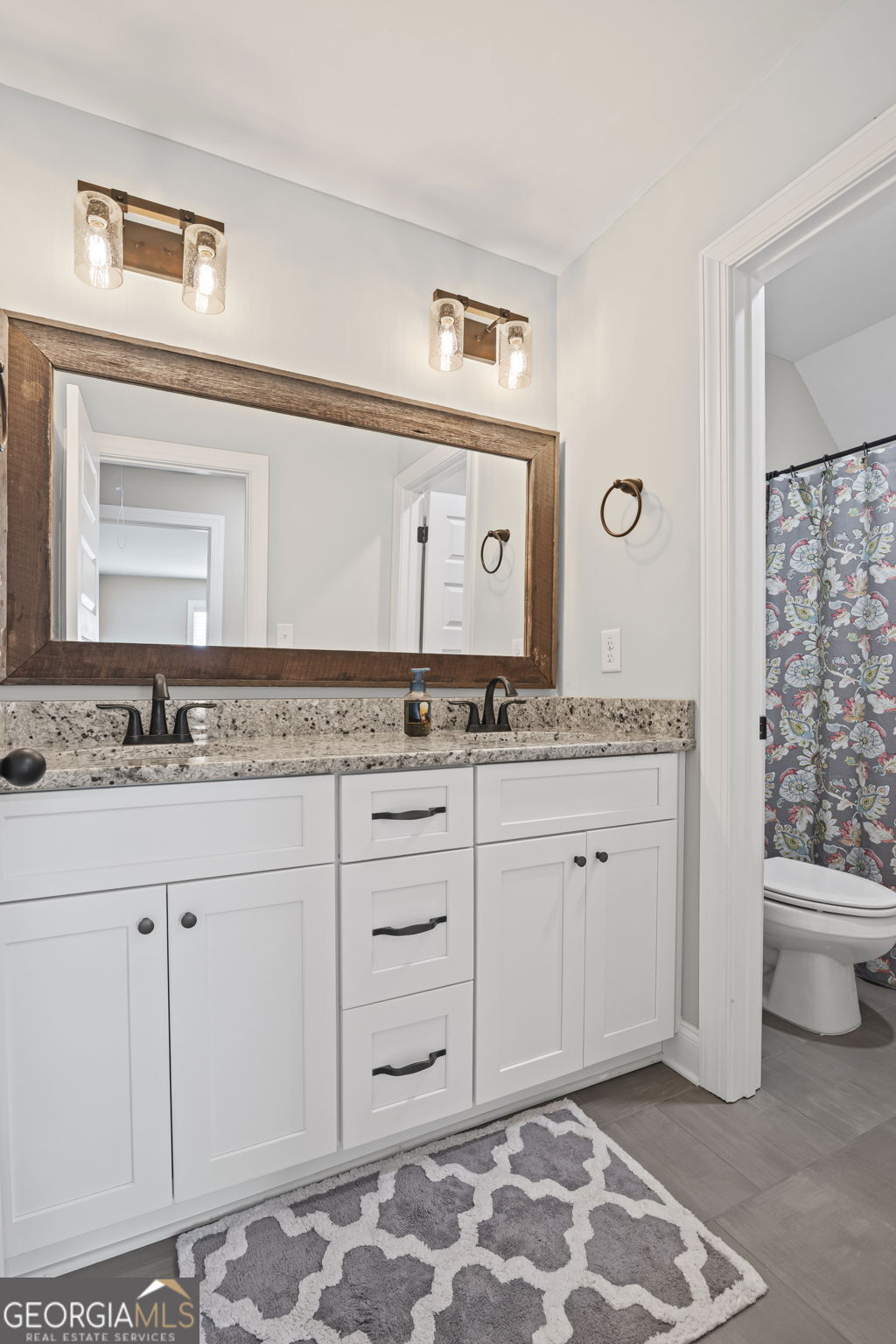 150 Duck Drive Senoia, GA 30276 - Photo 41 of 73 a spacious bathroom with a granite countertop sink and a mirror
