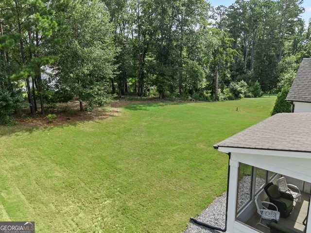 an aerial view of a house with a yard basket ball court and outdoor seating