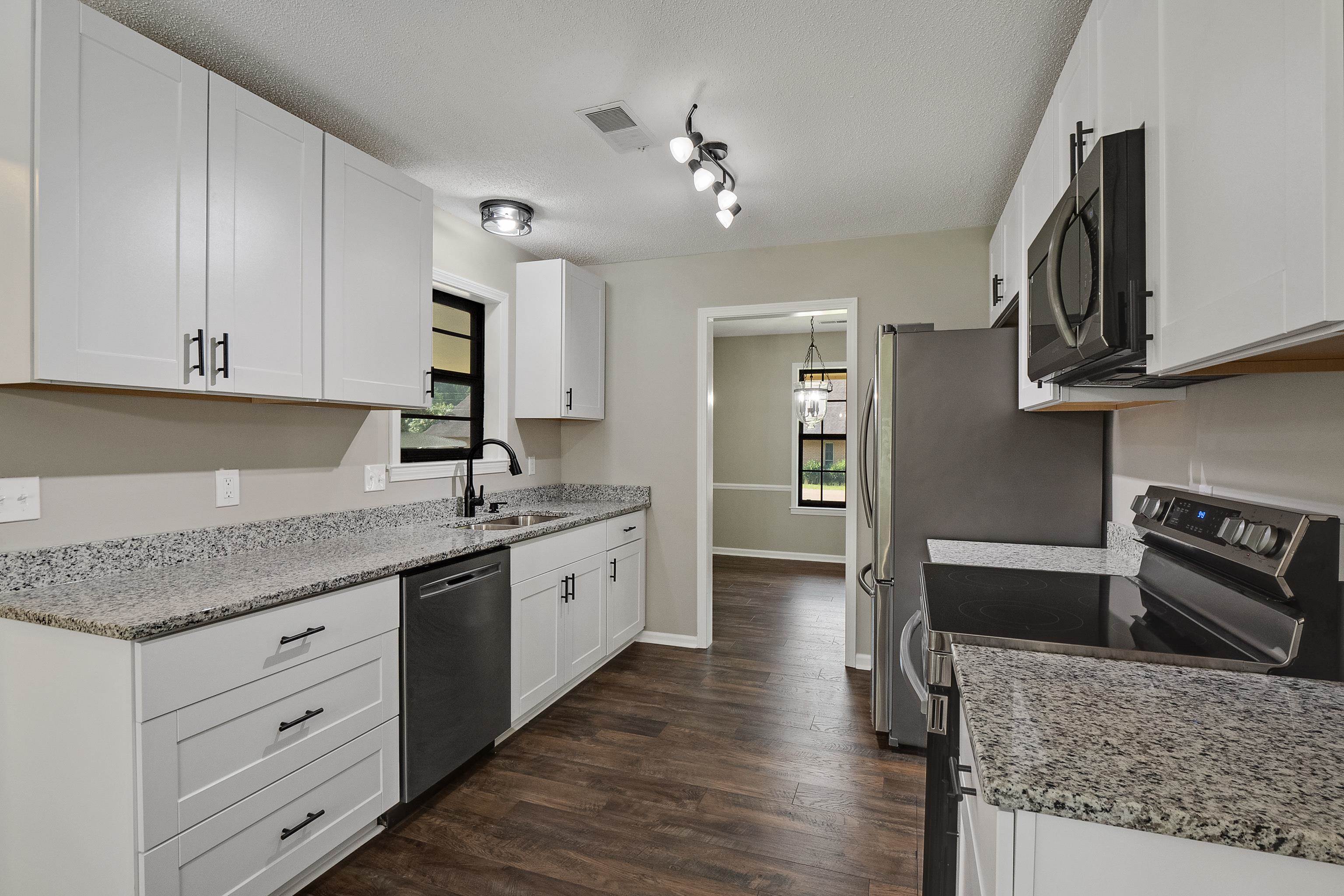 6384 Althorne Road Bartlett, TN 38134 - Photo 2 of 34 a kitchen with granite countertop a sink stainless steel appliances and cabinets