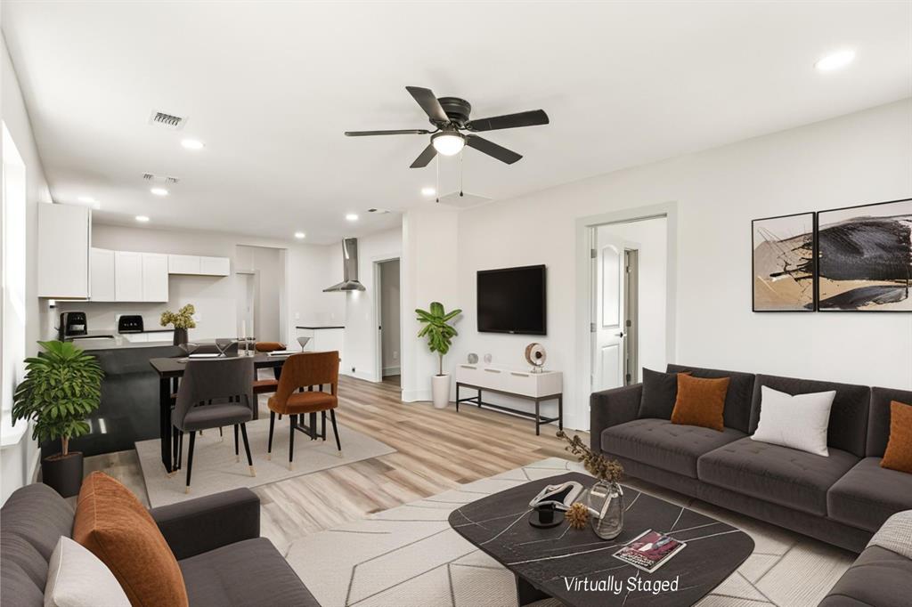 1127 West Morgan Street Denison, TX 75020 - Photo 1 of 23 a living room with furniture a flat screen tv and a window