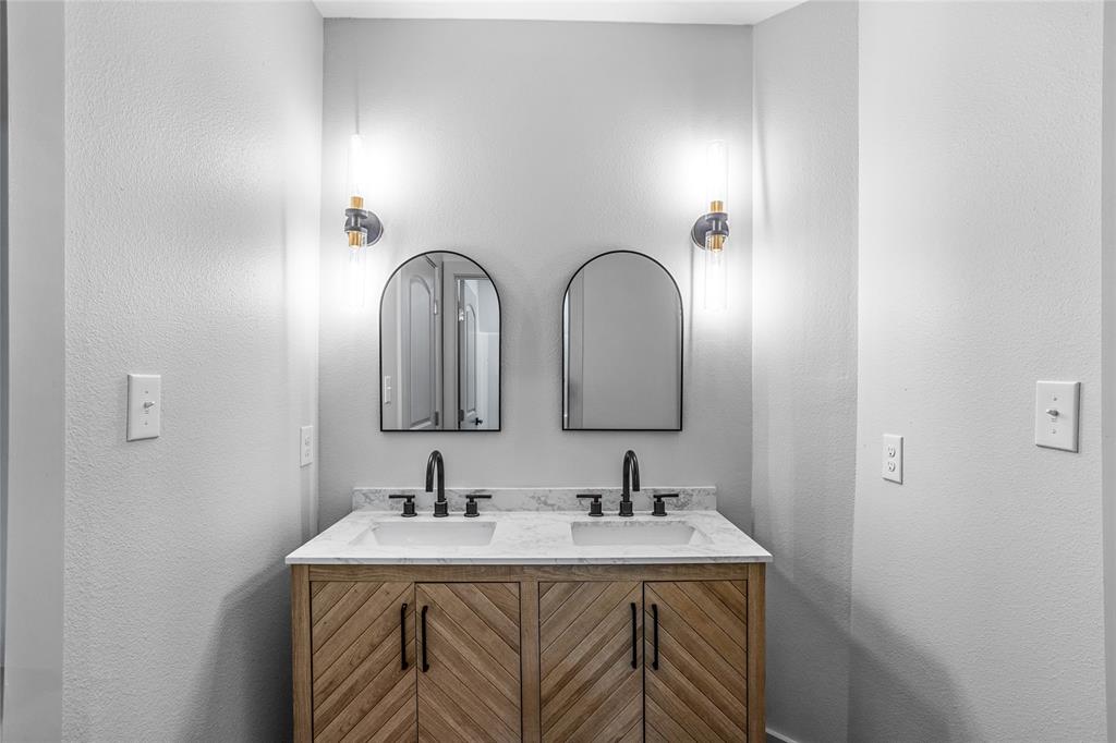 1127 West Morgan Street Denison, TX 75020 - Photo 11 of 23 a bathroom with a sink and a mirror