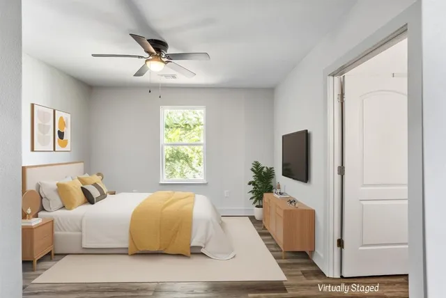 a bedroom with a bed and a flat screen tv
