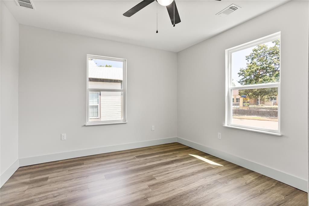1127 West Morgan Street Denison, TX 75020 - Photo 9 of 23 a view of empty room with wooden floor and window