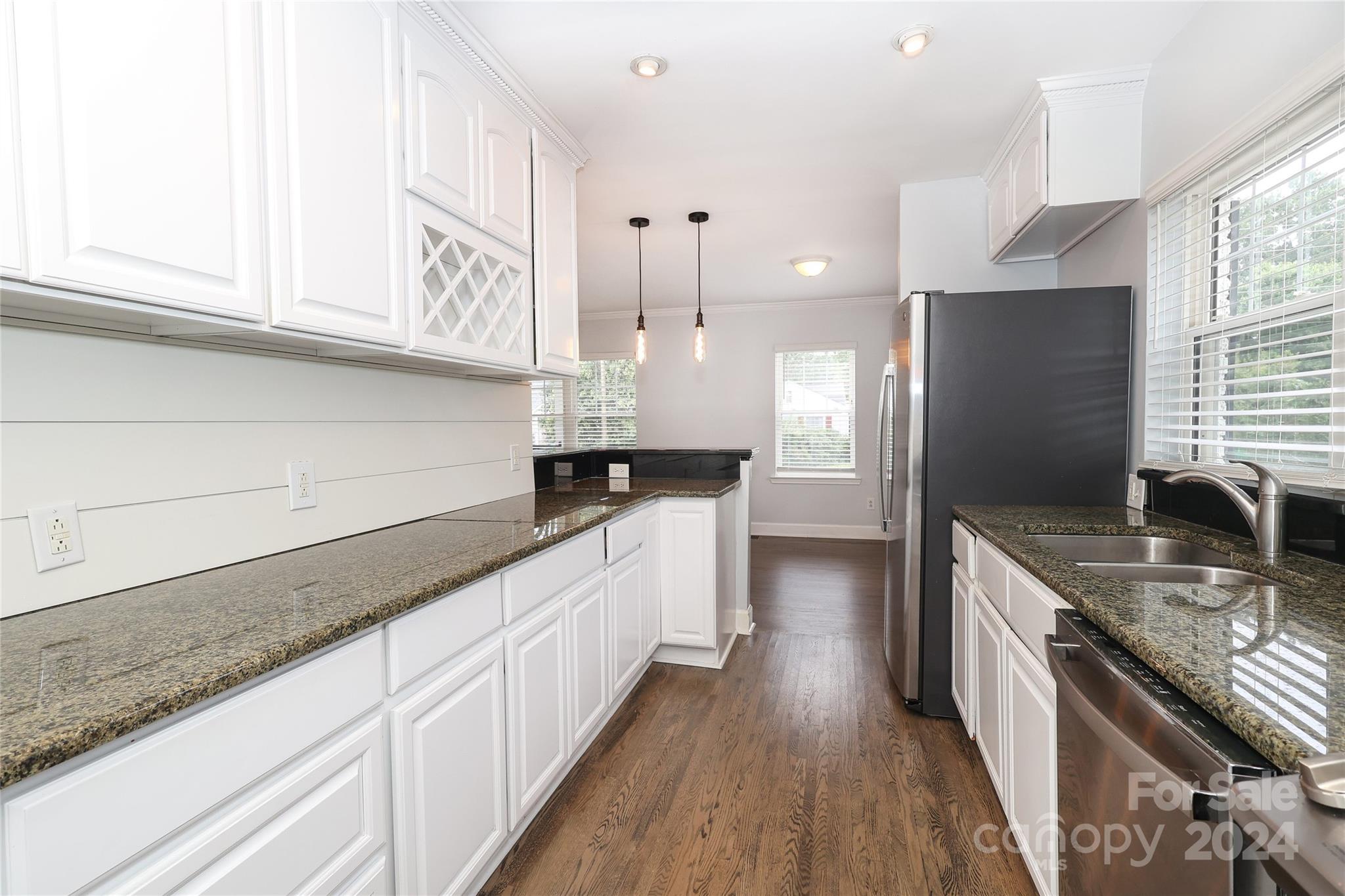 2012 Scott Avenue Charlotte, NC 28203 - Photo 15 of 43 a kitchen with granite countertop a sink a counter top space stainless steel appliances and cabinets