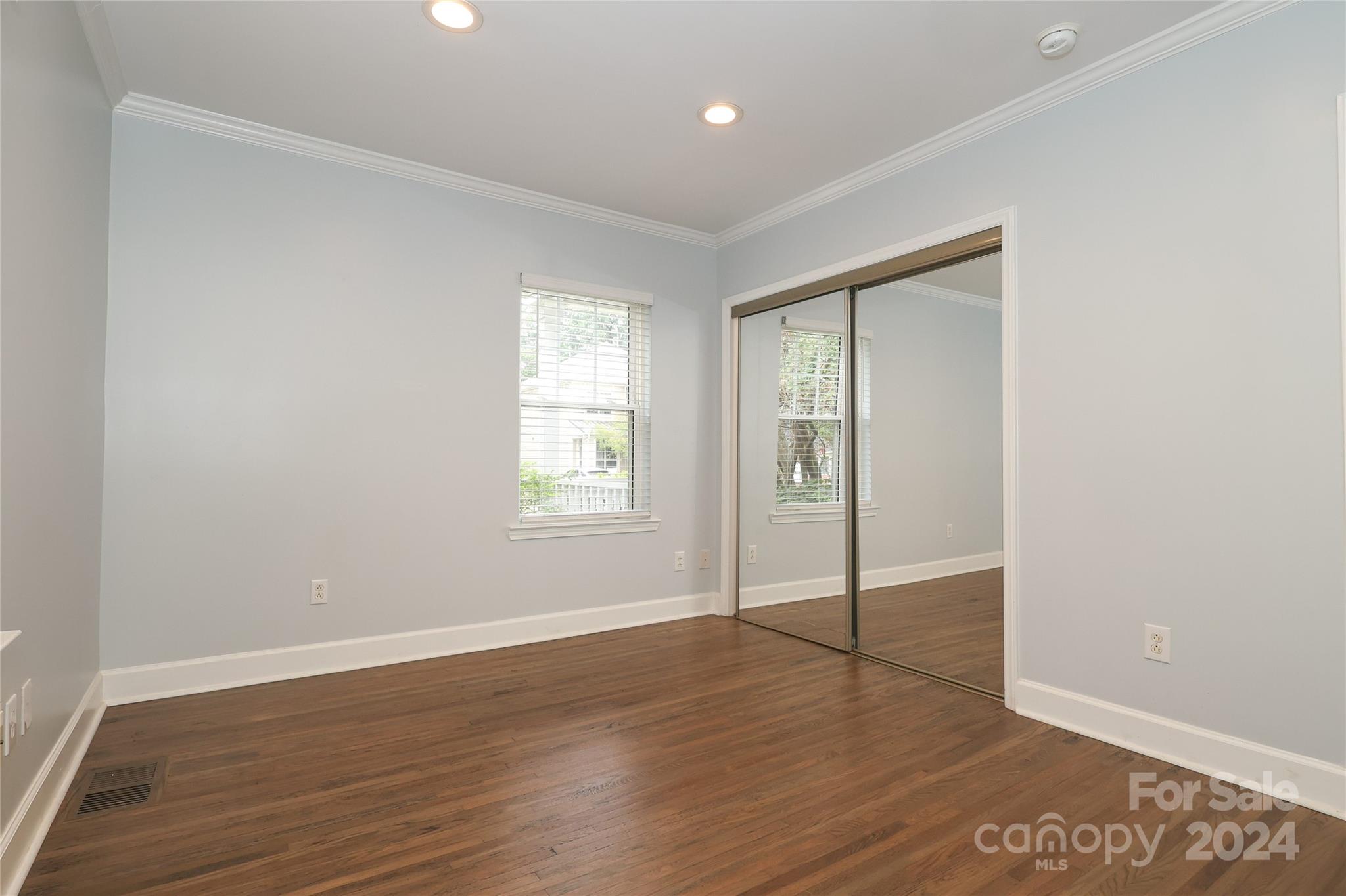 2012 Scott Avenue Charlotte, NC 28203 - Photo 19 of 43 an empty room with wooden floor and windows