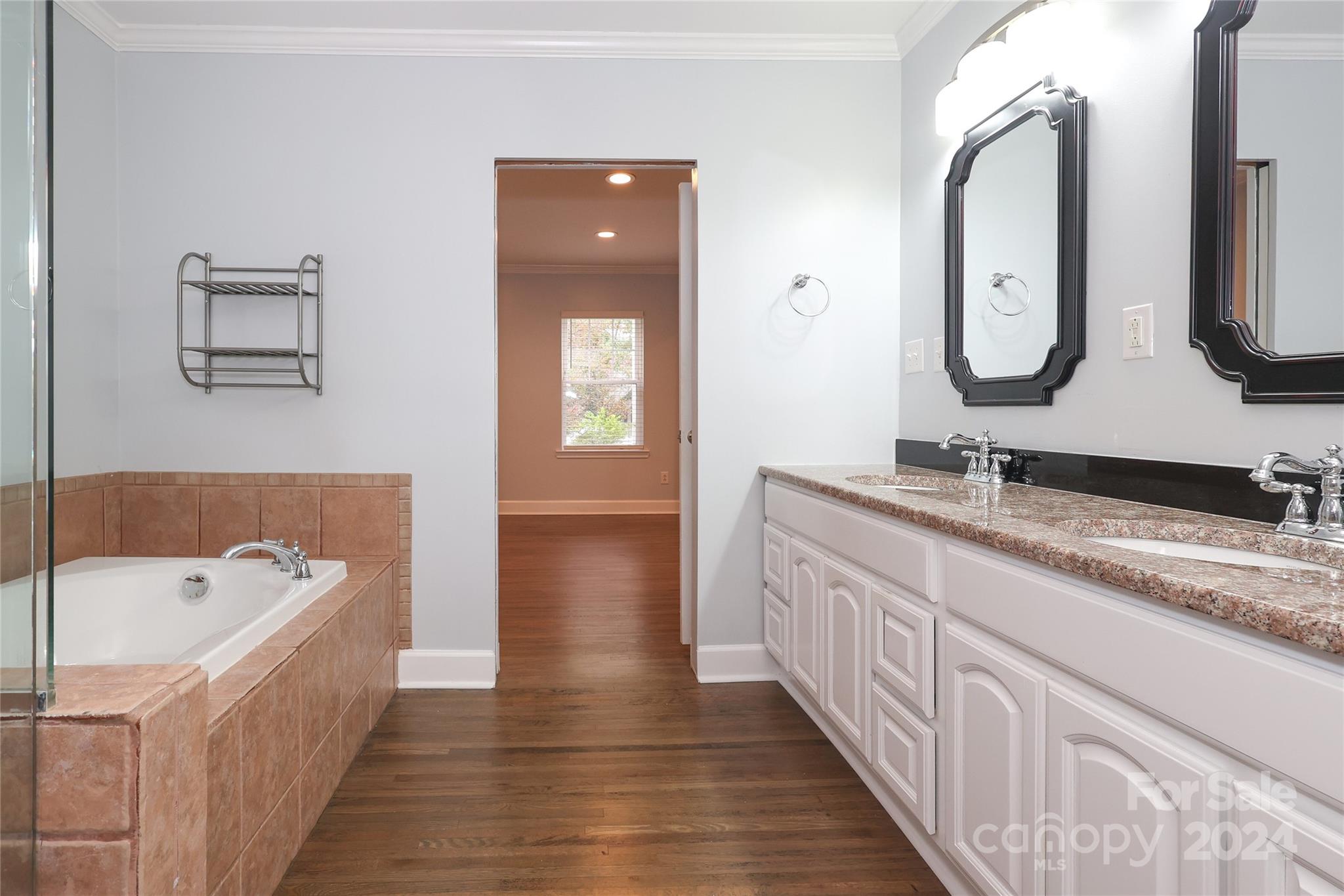 2012 Scott Avenue Charlotte, NC 28203 - Photo 28 of 43 a spacious bathroom with a double vanity sink and a mirror