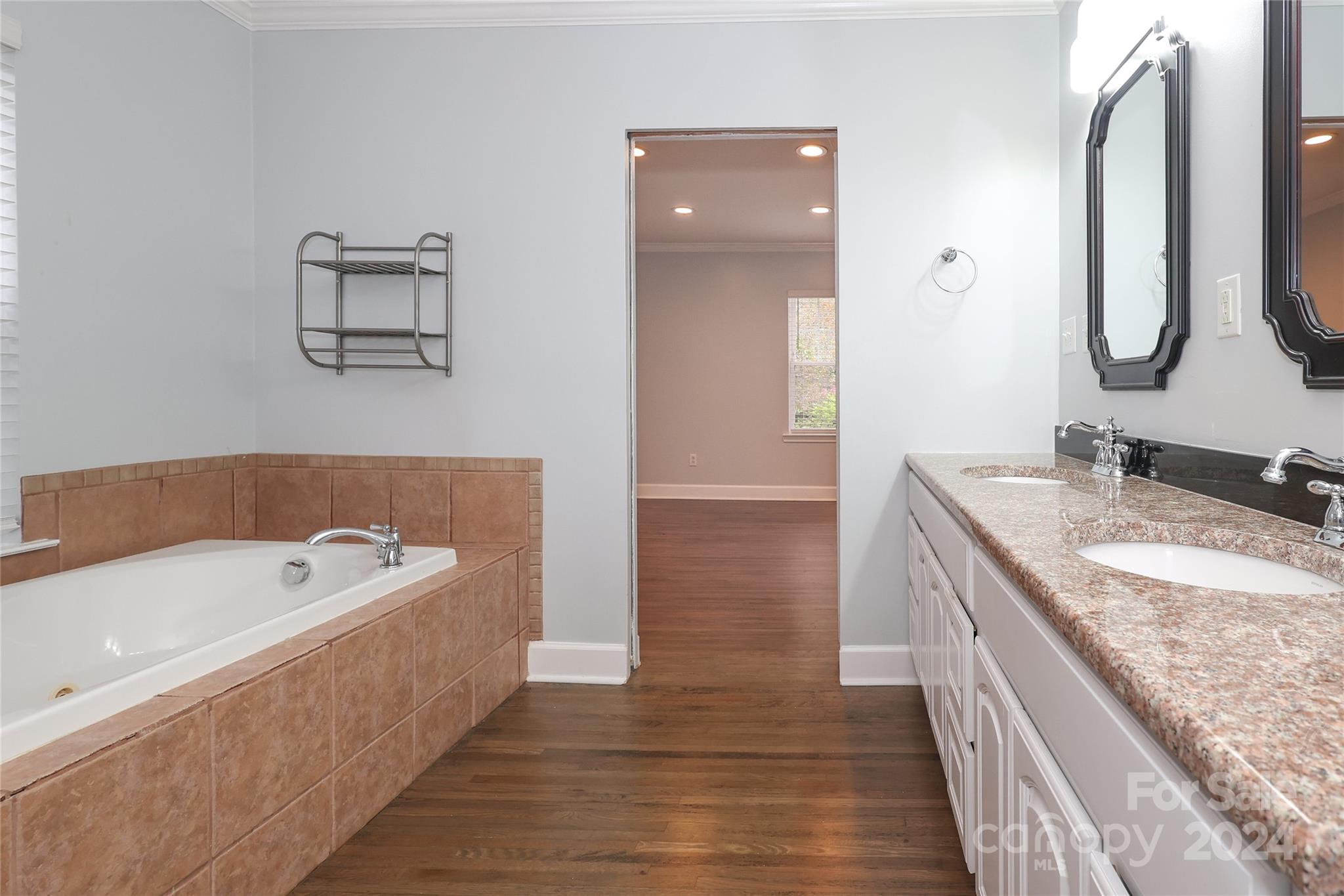 2012 Scott Avenue Charlotte, NC 28203 - Photo 29 of 43 a spacious bathroom with a granite countertop tub sink and mirror
