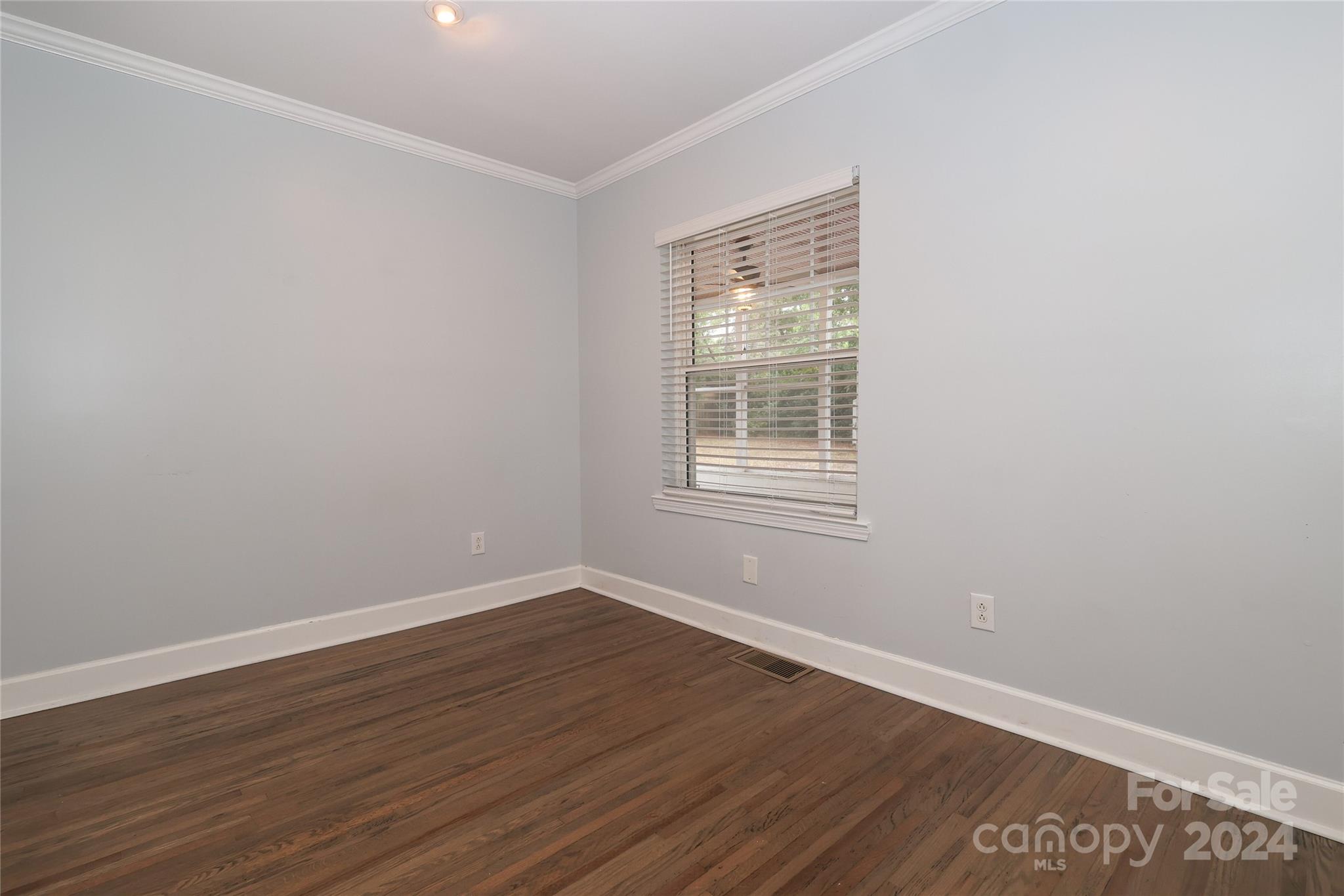 2012 Scott Avenue Charlotte, NC 28203 - Photo 31 of 43 an empty room with wooden floor and windows